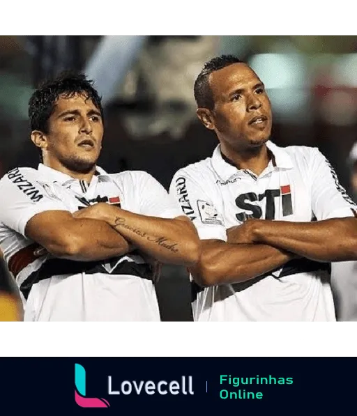 Dois jogadores do São Paulo Futebol Clube comemorando, abraçados e de uniformes brancos com detalhes pretos, durante jogo noturno