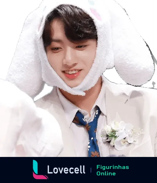 Membro do BTS sorrindo enquanto veste um chapéu de coelho branco felpudo. Ele está usando um terno bege com uma gravata azul e uma flor no paletó.