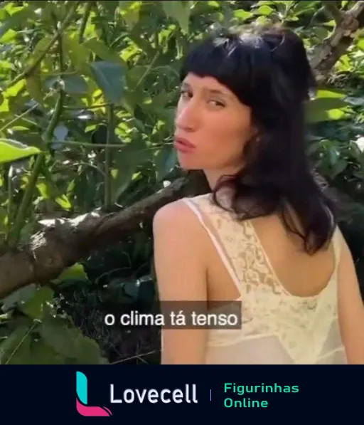 Mulher com cabelo preto curto fazendo bico e olhando de lado com a legenda 'o clima tá tenso', em ambiente ao ar livre com muitas folhas ao fundo