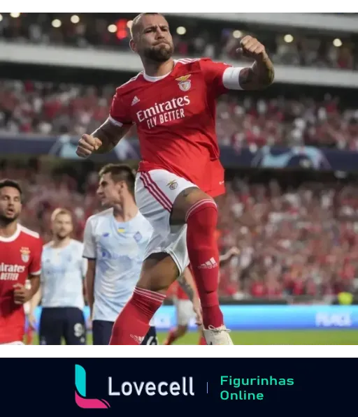 Jogador do Benfica celebrando gol com uniforme vermelho, camisa levantada mostrando abdômen e patrocínio da Emirates, com outros jogadores e público ao fundo