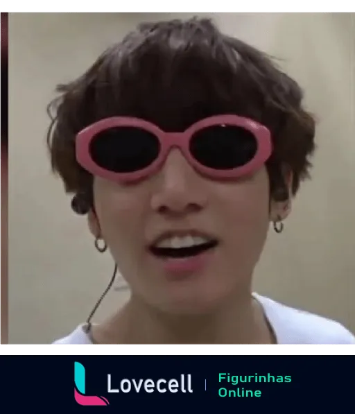 Membro do BTS usando óculos de sol rosa e brincos, sorrindo de maneira engraçada. Imagem divertida e descontraída.